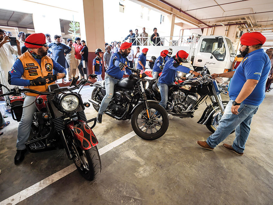 Turbaned riders donate food to workers in UAE camps | Society – Gulf News