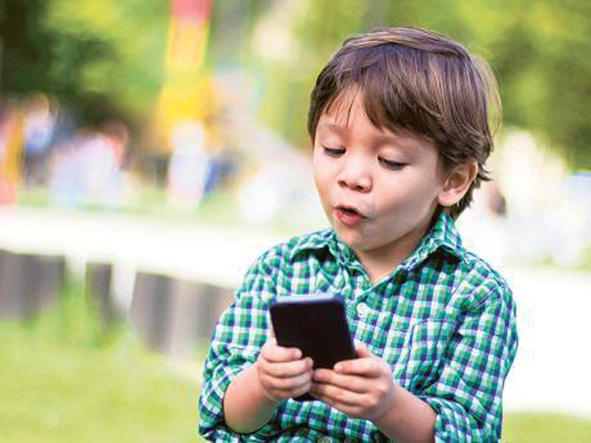 Little boy on his mobile phone
