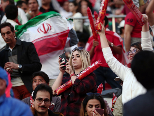 Iranian fans hold their national flag