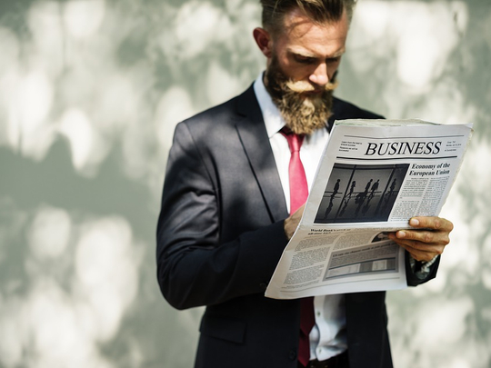 Illustrative image of man reading business paper