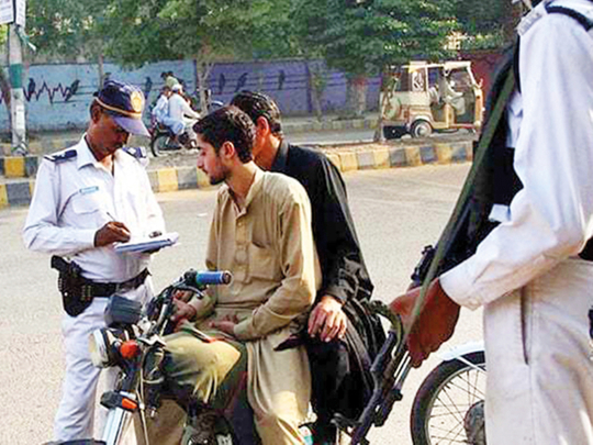 A traffic police officer in Karachi fines