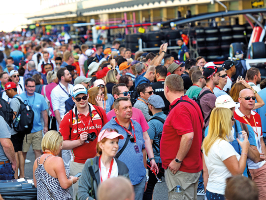 Formula 1 fans walk the pit lane