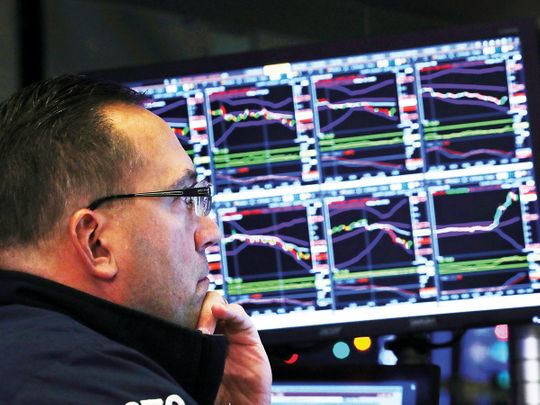 A trader looks at price monitors