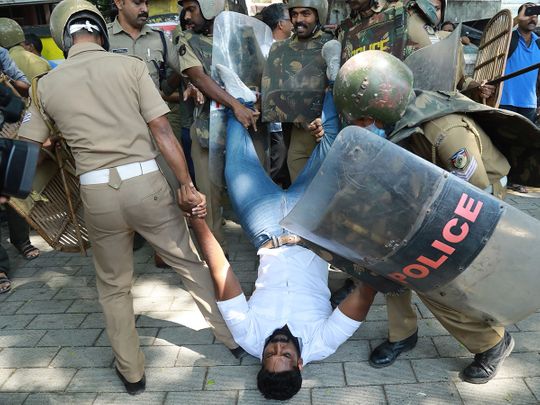 Police detain an activist
