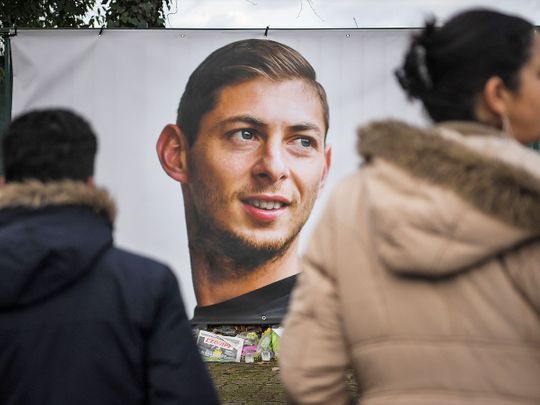 People look at a portrait of Emiliano Sala