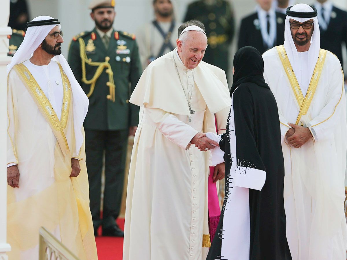 Pope Francis shakes hands with Amal Al Qubaisi