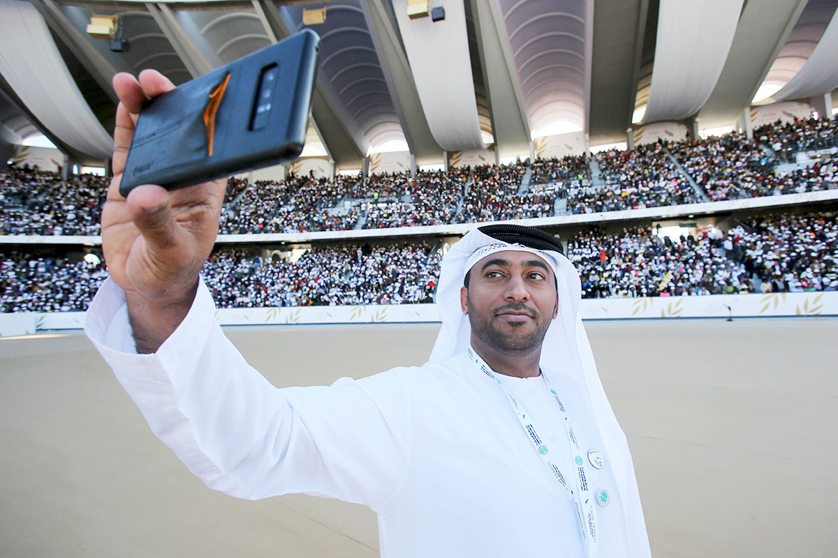 An Emirati official takes a selfie