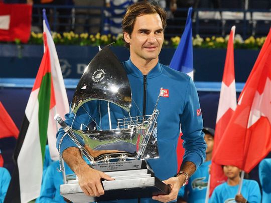 Roger Federer holds his trophy