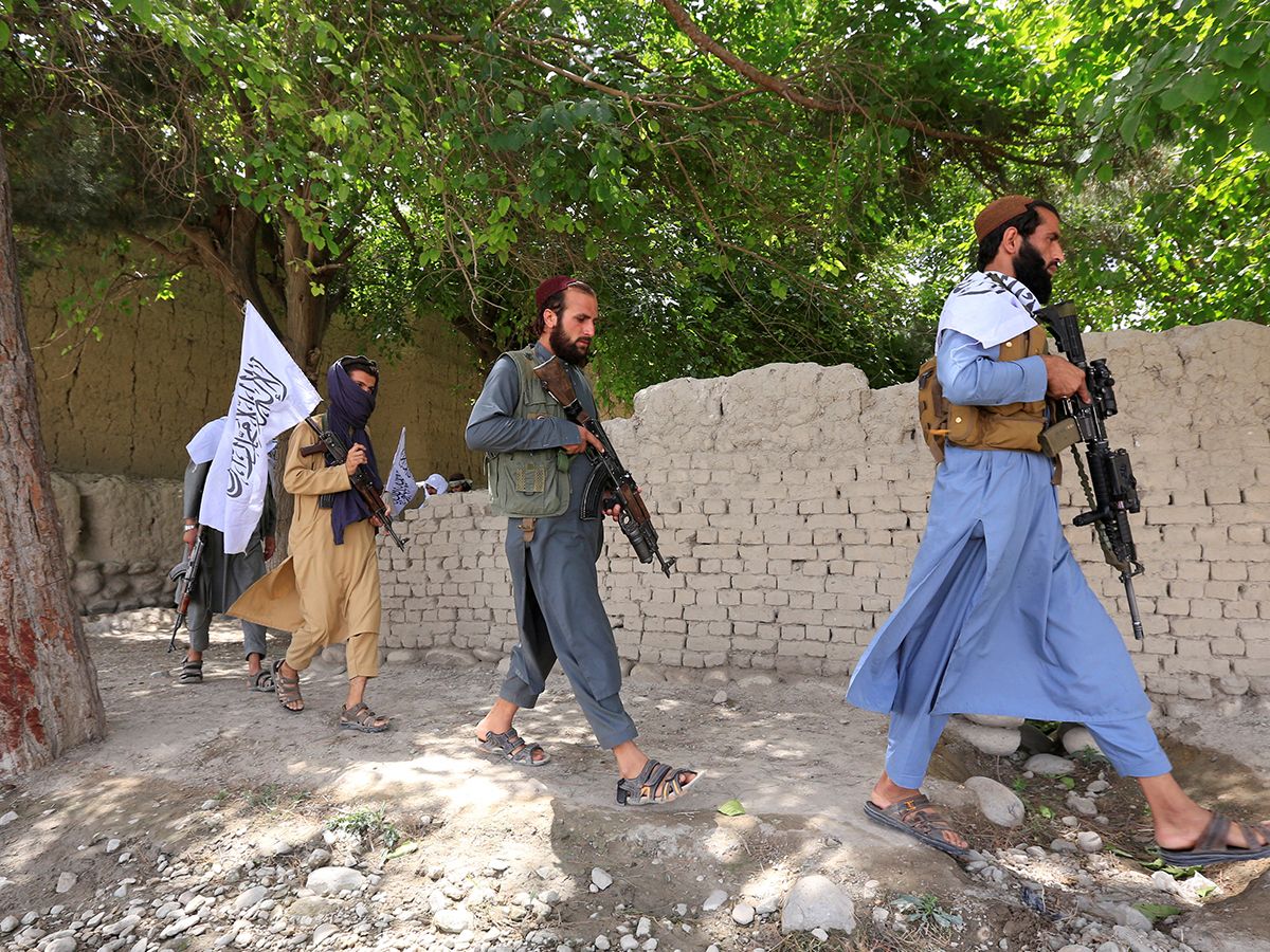 Taliban men walk as they celebrate ceasefire in Ghanikhel district