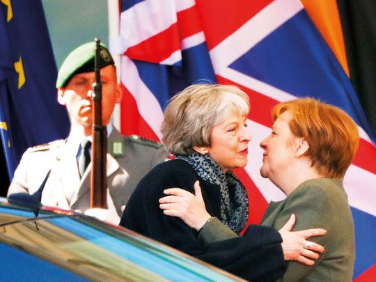 German Chancellor Angela Merkel kisses British Prime Minister Theresa May