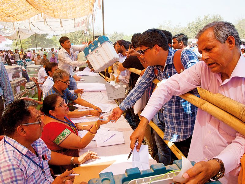 Polling officers collect election material in Ghaziabad