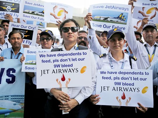 Employees of Jet Airways hold placards