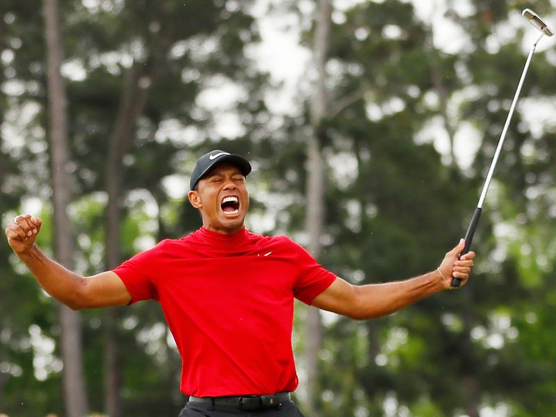 Tiger Woods celebrates on the 18th hole after winning the 2019 Masters