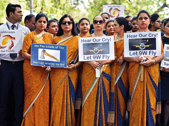 Cabin crew hold placards during a protest organided by Jet Airways employees