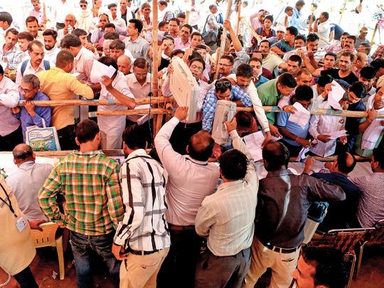 Polling officials collect EVMs at a distribution centre