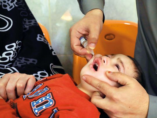 A boy receives polio vaccine