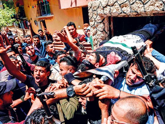 Mourners carry the body of 22-year-old Palestinian Emad Nasser