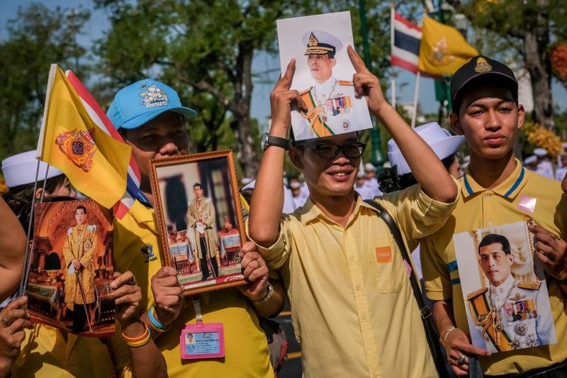 People hold portraits of Thailand's King Maha 012