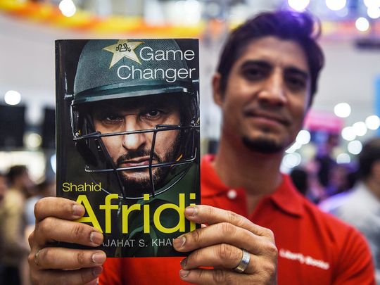 A cricket fan holds Shahid Afridi's autobiography