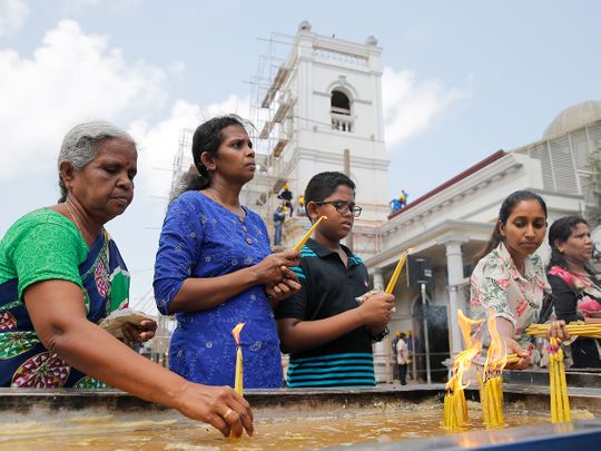 Sri Lankan Catholic devotees light candles