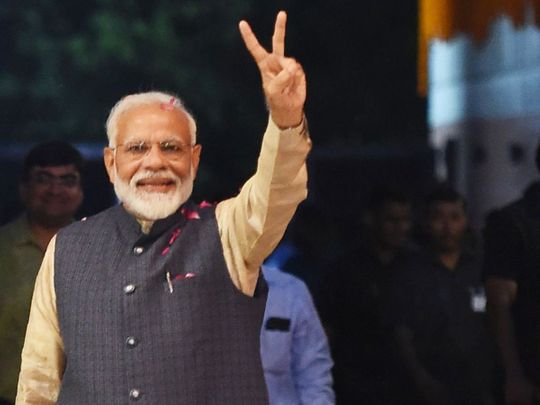 Prime Minister Narendra Modi flashes the victory sign 