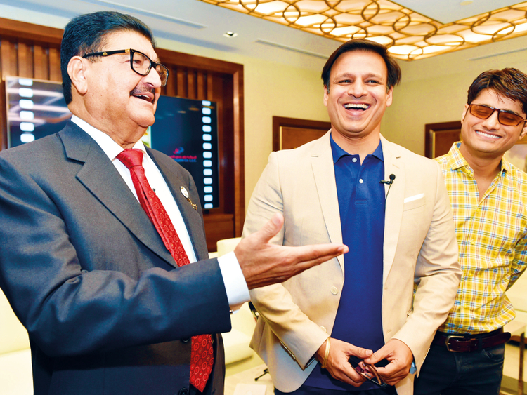   Vivek Oberoi with United Arab Emirates businessman BR Shetty and PM producer Narendra Modi, Sandip Ssingh. 