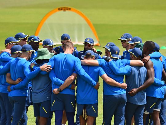 South Africa's players and coaches form a group huddle