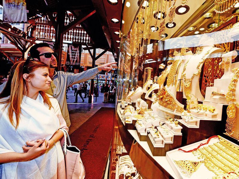 Customers look at jewellery in the Deira Gold Souq