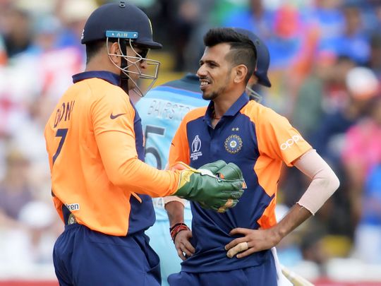 India's MS Dhoni (left) speaks with Yuzvendra Chahal