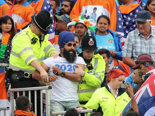 A handcuffed Sikh spectator 