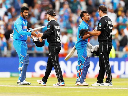 New Zealand players greet Indian batsmen Jasprit Bumrah