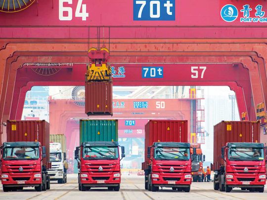 Trucks being loaded at the container port in Qingdao