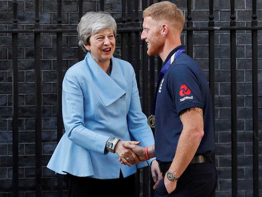 Britain's Prime Minister Theresa May shakes hands with England's Ben Stokes 