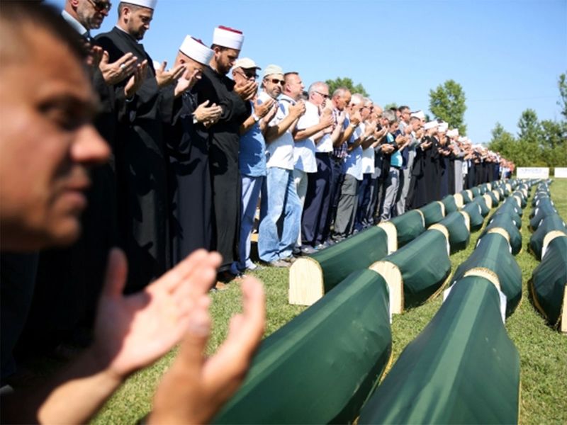Bosnian Muslims pray during a mass funeral in the village of Kamicani, near Prijedor, Bosnia and Herzegovina, July 20, 2019.  