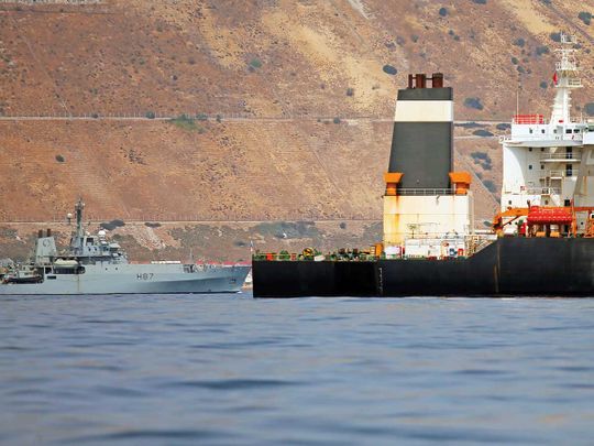A British Royal Navy patrol vessel guards the Iranian oil tanker Grace 1