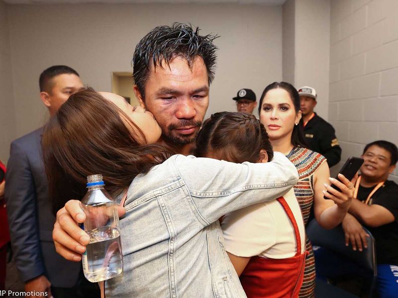 Manny Pacquiao (C) celebrating with members of his family 