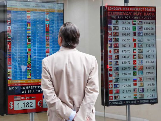 A man looks at a rate list at a currency exchange bureau