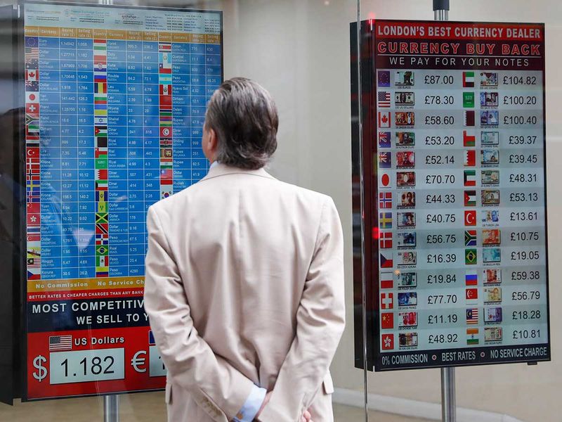 A man looks at a rate list at a currency exchange bureau