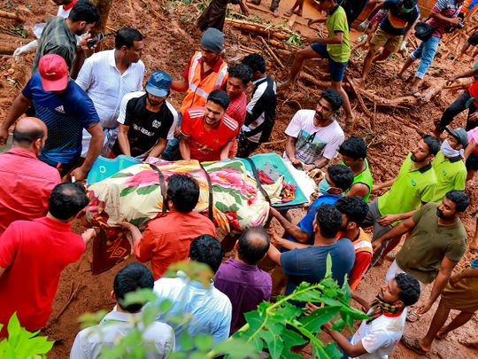 Rescue workers shift a body