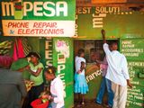 Residents transfer money using the M-Pesa banking service at a store in Nairobi