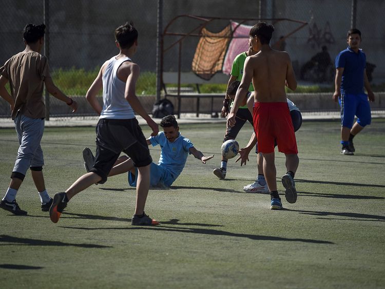 Young rugby players take part in a practice session on a pitch in Kabul