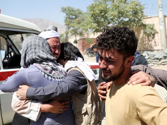 Afghan men comfort each other