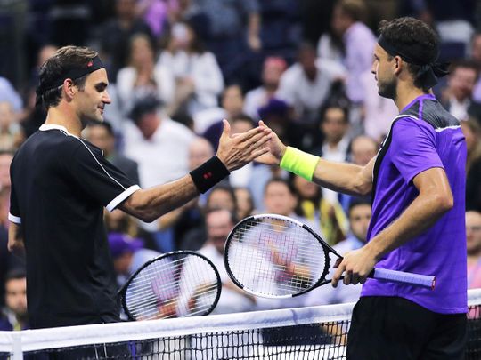 Grigor Dimitrov, of Bulgaria, right, shakes hands with Roger Federer