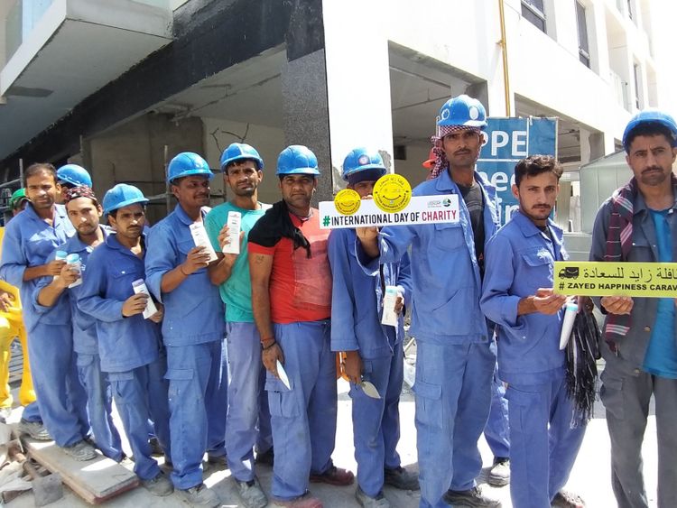Laborers receiving food & gifts at construction site on the occassion of International Day of Charity - 05-09-2019 pic 5-1567772989296
