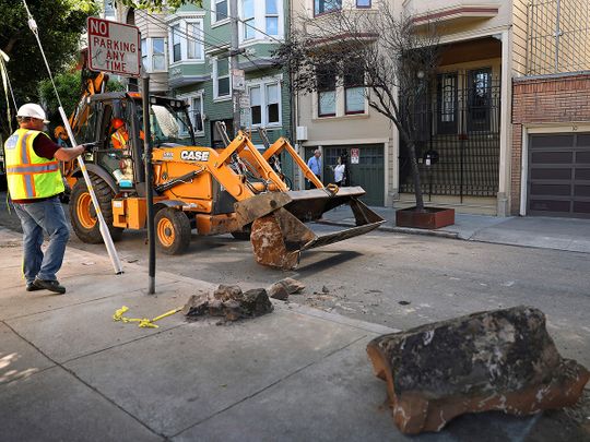 A San Francisco Public Works crew removes boulders