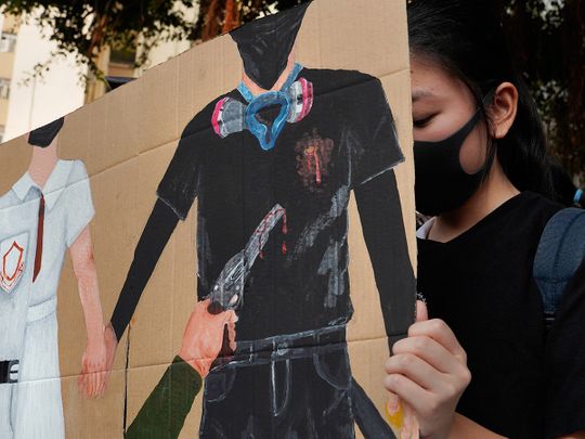 A supporter raises a printing featuring a protester shot