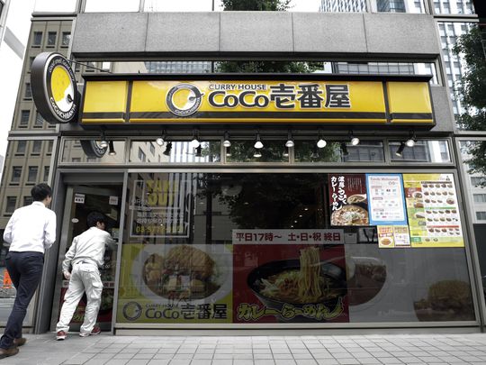 Customers enter a CoCo Ichibanya restaurant, operated by Ichibanya Co., in Tokyo.-1571399661045