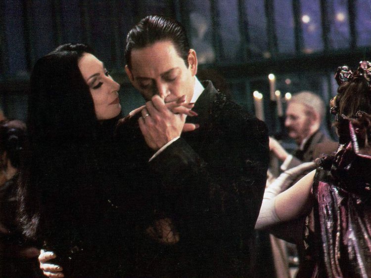 Raul Julia and Anjelica Huston in The Addams Family (1991)-1572499357368
