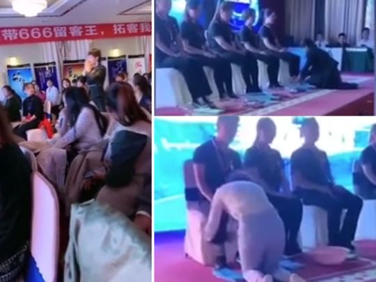 Chinese boss kneels on the ground to wash feet for her top-performing sales staff