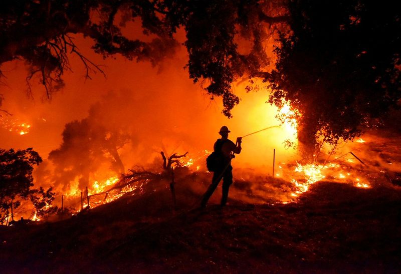 Santa Barbara City firefighter Erik Adair battles flames